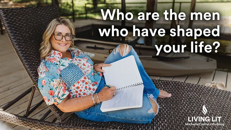 Michelle sits smiling on a wicker chair while journaling in a notebook on a lakeside deck, with a kayak behind her. Text reads: Who are the men who have shaped your life?